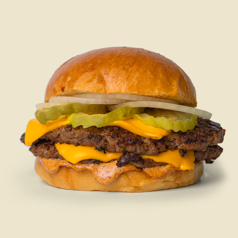 Artisan burger bun, 4 oz 100% chuck roast patty, american cheese, pickles, white onions and house special sauce.