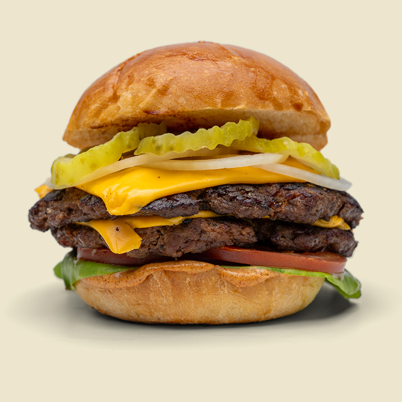 Artisan burger bun, butterhead lettuce, tomato, 4 oz 100% chuck roast patty, american cheese, white onion, pickles and house special sauce.